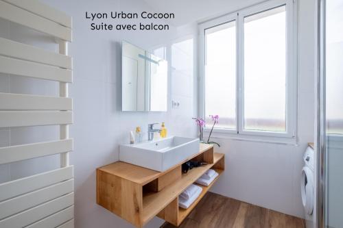 a bathroom with a white sink and a mirror at Lyon Urban Cocoon Gîte urbain eco-responsable in Lyon