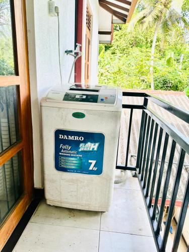 a trash can sitting on the porch of a house at Dinsara Villa Mirissa,Kamburugamuwa in Kamburugamuwa