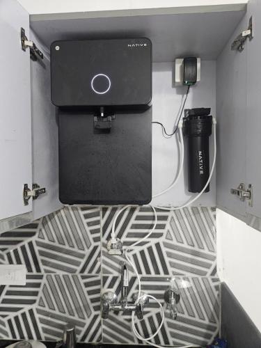 a bathroom with a sink with a water tank and a sink at The Cozy Petals in Gaya