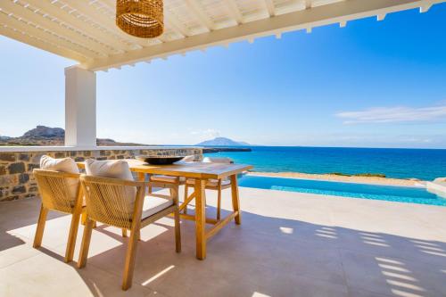 a dining room with a view of the ocean at Terramare Villas Karpathos in Foinikion