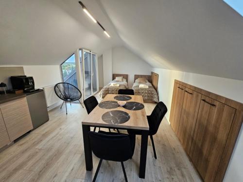 a room with a table and a bed in it at Apartament KONGRESOWA VIEW in Kielce