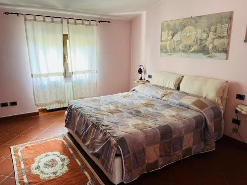 a bedroom with a large bed and a window at Le Valli di Piero in Monterchi
