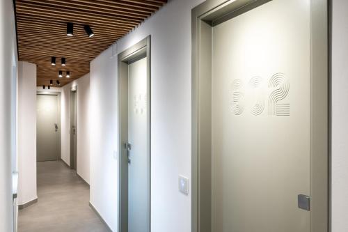 a corridor in a office building with white walls and wooden ceilings at Albergo Ristorante Corsini in Pavullo nel Frignano