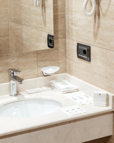 a bathroom with a sink and a mirror at Hotel Diamond in Baku