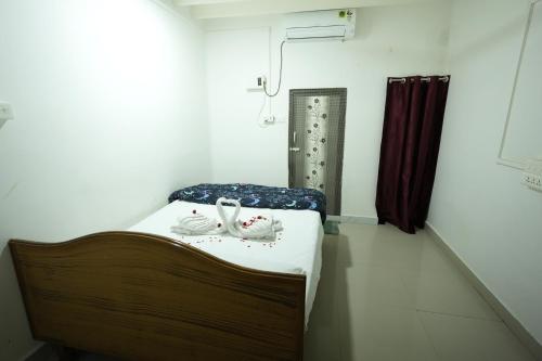a hospital room with a bed with shoes on it at ABM Homestay in Thanjāvūr