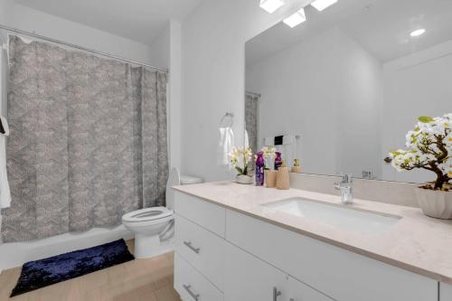 a white bathroom with a sink and a toilet at Downtown Atlanta Home Away from Home - 2 in Atlanta