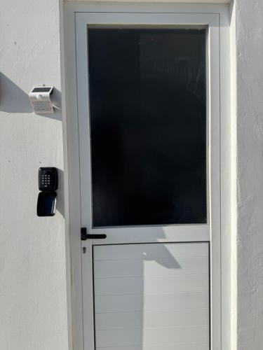 a white door with a window in it at Sunflight Apt 01B One Bedroom Apt in Larnaka