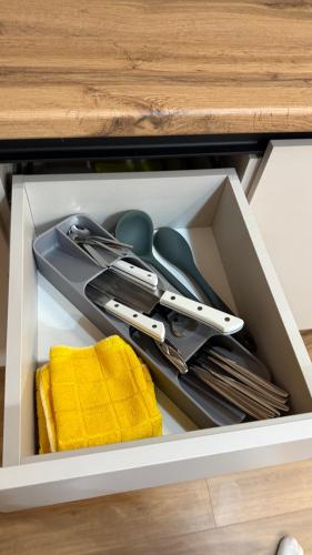 a drawer filled with utensils in a cabinet at U-tower 18 apartment in Chilanzar