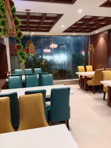 a dining room with tables and chairs at Royal SeaView in Digha