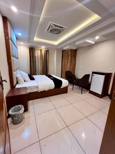 a hotel room with a bed and a desk in it at Mehboob international hotel murree in Murree