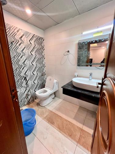 a bathroom with a sink and a toilet at Mehboob international hotel murree in Murree