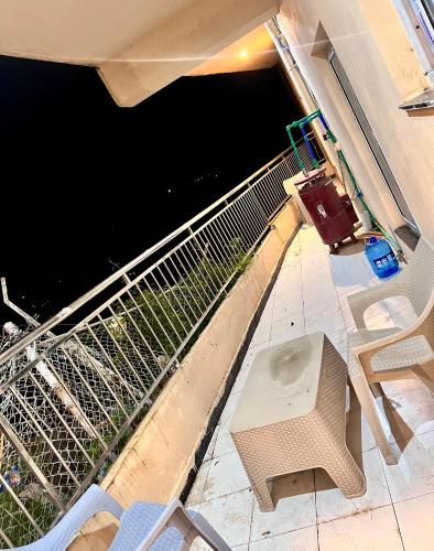 a balcony with a bench and a view of the water at Mehboob international hotel murree in Murree