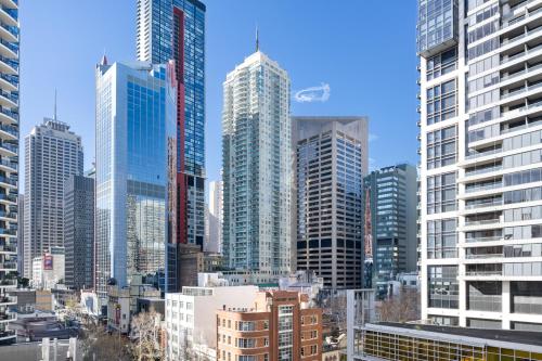 a view of a city with tall buildings at Perfectly Located CBD 3 bedrooms Apartment in Sydney