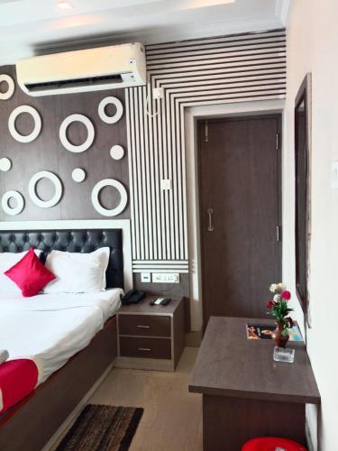 a hotel room with a bed and a desk at Royal SeaView in Digha