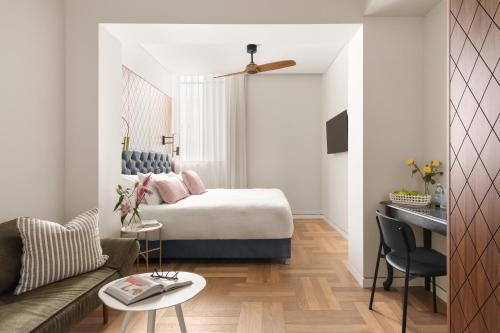 a hotel room with a bed and a couch at Hotel RECEPTION in Tel Aviv