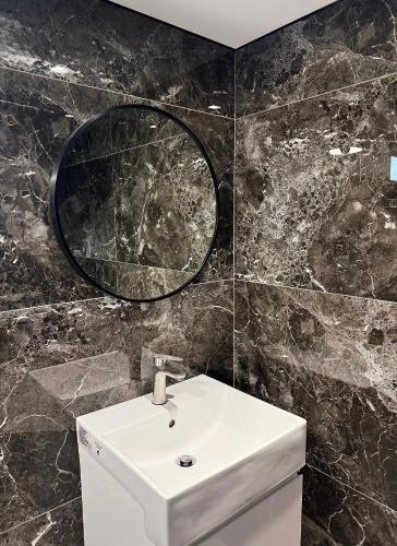 a bathroom with a sink and a mirror at Muchun Villa in Sanxing