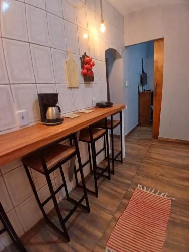 a kitchen with a wooden table in a room at BLUE HOUSE CONEXÃO ILHA GRANDE in Abraão
