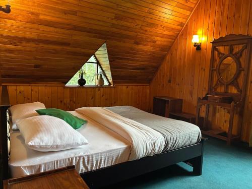 a bedroom with a bed in a wooden room at Jaithra Inn in Nuwara Eliya