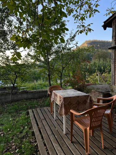 a table and chairs sitting on a wooden deck at маленькое шале в с.Строенцы in Stroieşti