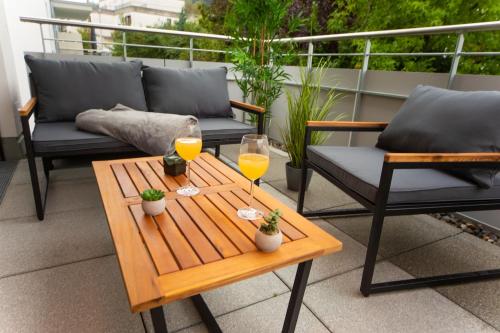 two glasses of orange juice on a table on a balcony at P-Hosting BohoStyle Rv1 in Ravensburg