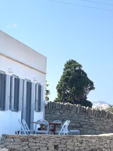 a group of chairs and a table in front of a building at Sifnos Blue Horizon House Kastro Endless Blue in Apollonia