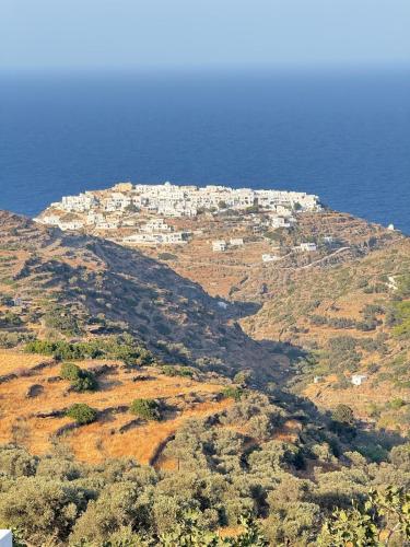 a village on top of a hill near the ocean at Sifnos Blue Horizon House Kastro Endless Blue in Apollonia