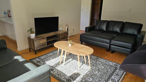 a living room with a couch and a table at Te Anga Farmstay in Te Kuiti