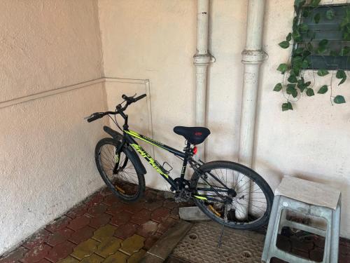 a bike parked against a wall in a corner at Spacious 3 BHK Villa, Lonavala in Lonavala