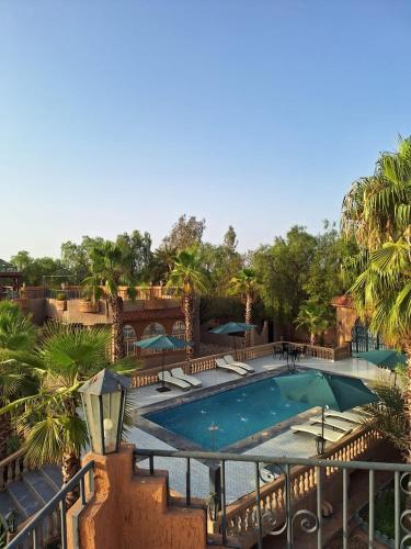 a large swimming pool with chairs and umbrellas at Eden Suites 