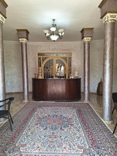 a large room with a table and a large rug at Eden Suites 