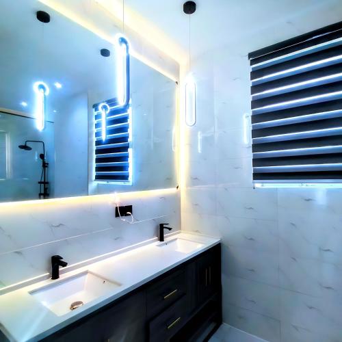 a bathroom with a sink and a mirror at Ifemide Estates - Luxury Homes in Akure