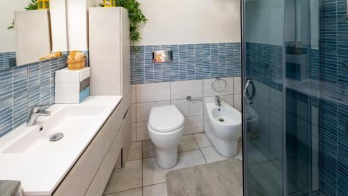 a bathroom with a toilet and a sink and a shower at Galatea Executive Sea View in Aci Castello