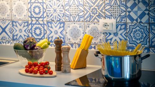 a counter top with a blender and a bowl of vegetables at Galatea Executive Sea View in Aci Castello