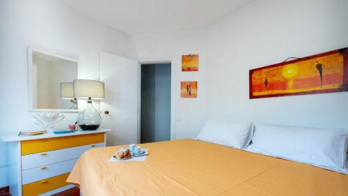 a bedroom with a bed and a dresser and a mirror at Galatea Executive Sea View in Aci Castello