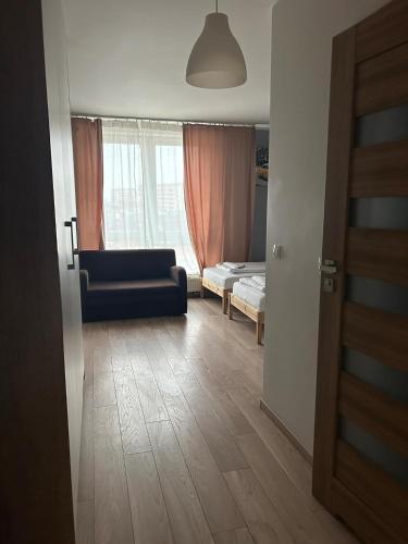 a living room with a couch and a bedroom at Residence Aparthotel in Szczecin