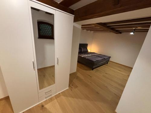 a bedroom with a bed and a closet in a room at Jenbachnest in Bad Feilnbach