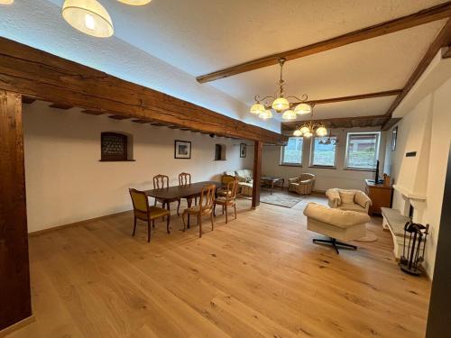 a dining room and living room with a table and chairs at Jenbachnest in Bad Feilnbach