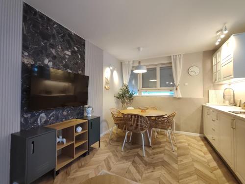 a kitchen and dining room with a table and chairs at Dream Oasis in Banja Luka