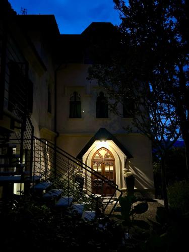 a building with a lit up door at night at Hotel Villa Giulia in Gargnano