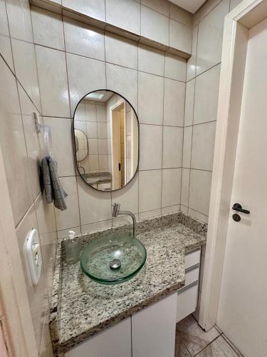 a bathroom with a sink and a mirror at Apê Brisa do Mar in Pontal do Paraná