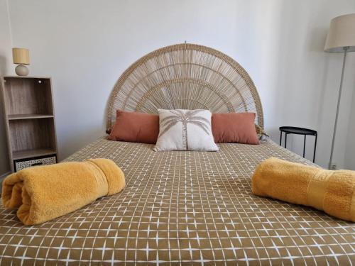 a large bed with two pillows on top of it at Beau T3 avec grande terrasse centre Alès in Alès