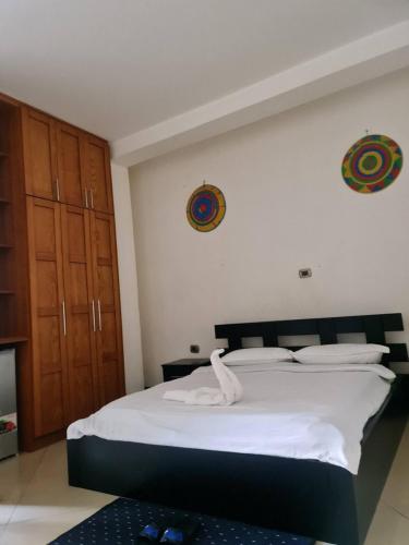 a bedroom with a large bed with white sheets at Hanom Hotel in Addis Ababa