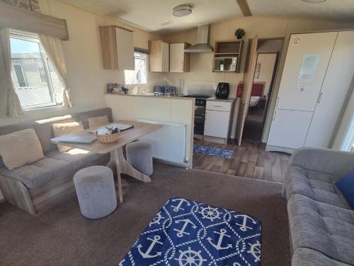 a living room with a table and a kitchen at Spacious accomodation 188 Unity Beach sleeps 6 Centrally located Pet friendly Pets Stay Free in Brean