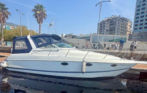 a white boat is docked in the water at Barco la bella in Vigo