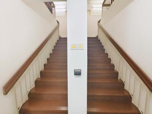 a spiral staircase in a building with wooden floors at Bahagia Stay Georgetown in George Town