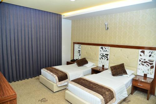 Katil atau katil-katil dalam bilik di Dynasty Hotel