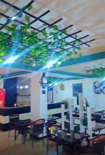 a dining room with tables and chairs and lights at Hanom Hotel in Addis Ababa