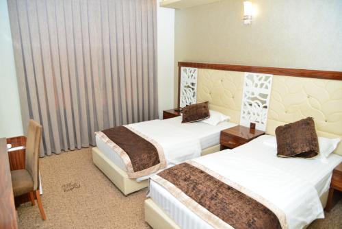 Katil atau katil-katil dalam bilik di Dynasty Hotel