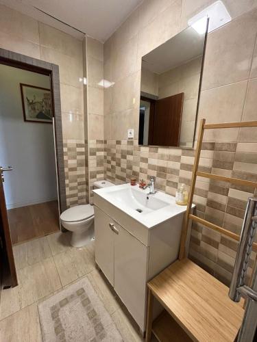 a bathroom with a sink and a toilet and a mirror at Casa do Ruben Lisboa in Lisbon