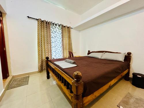 a bedroom with a wooden bed in a room at The Mystic Cliff Varkala in Varkala